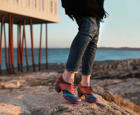 The Hopeful Vow: A Fogo Island collaboration shoe with laces in purple, orange and blue.